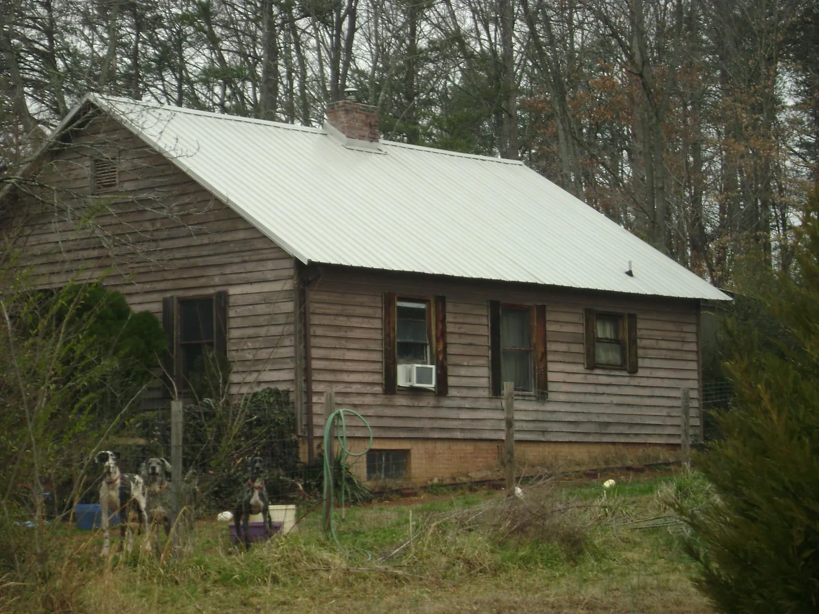 White metal roof on an old wood sided farmhouse, from a Metal Roof Installation job in Elliottsburg